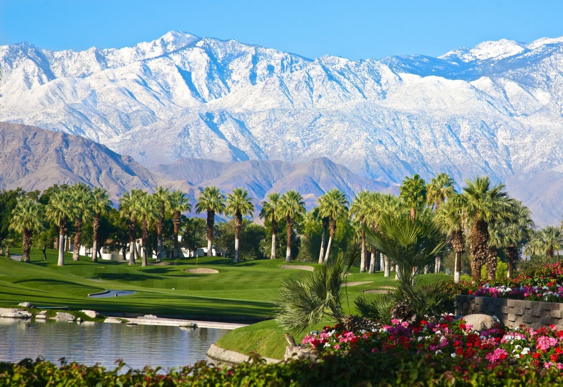 A Valley Course green with snow-dusted peaks standing over the valley