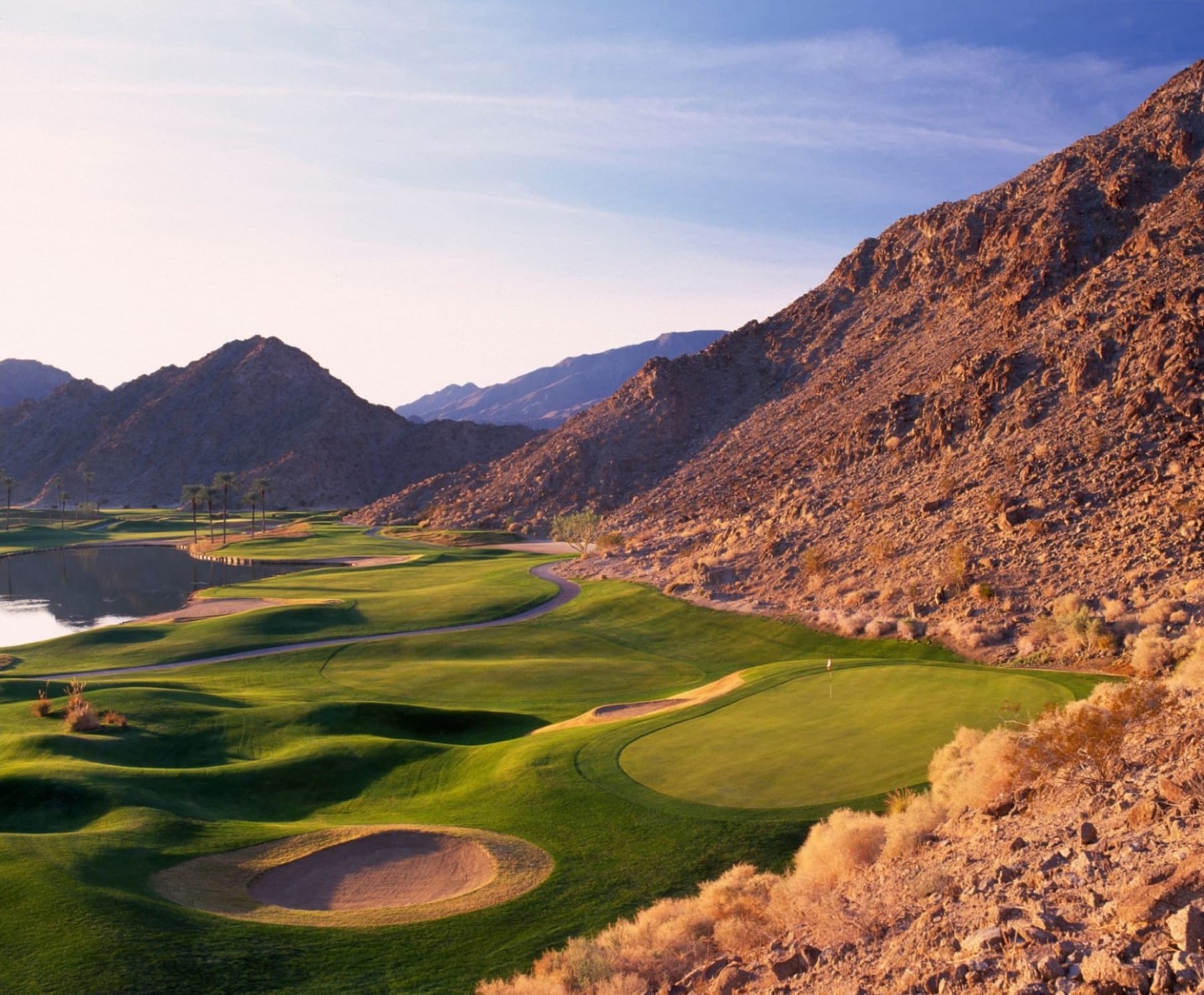 A Mountain Course green tucked hard against the Santa Rosa rock at last light