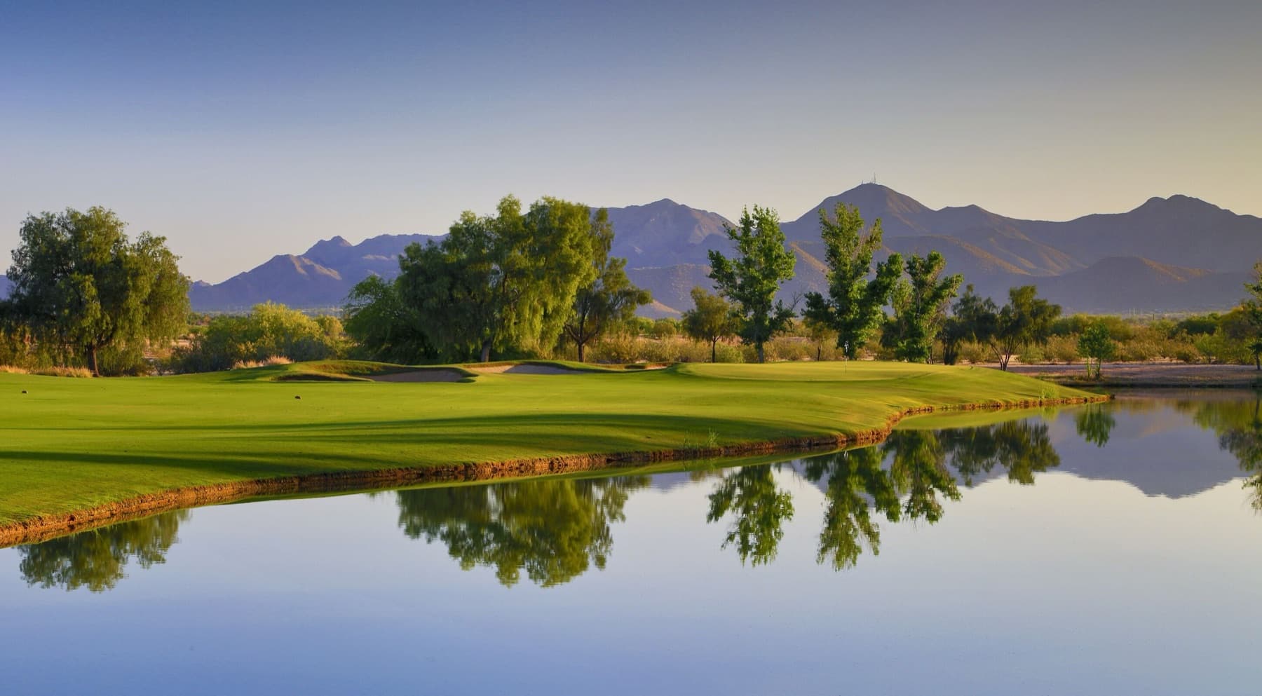 an open green with water and the McDowells beyond